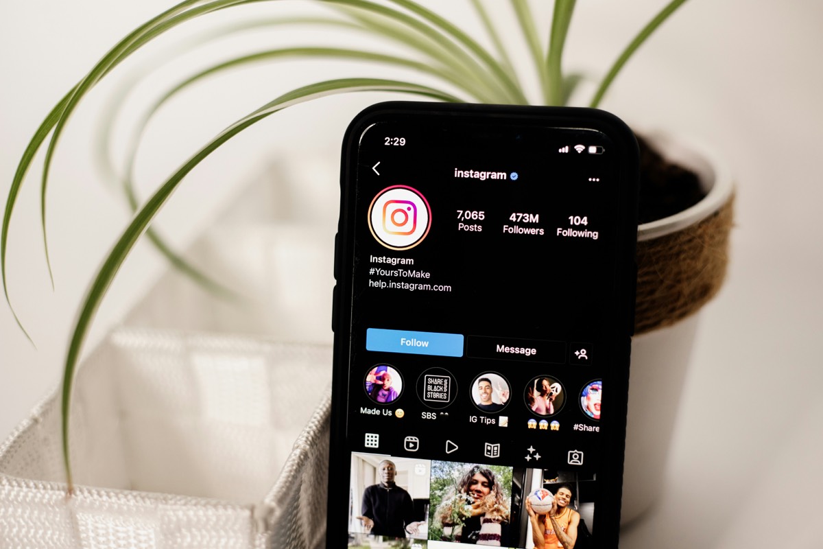 Phone showing Instagram profile with curated feed layout